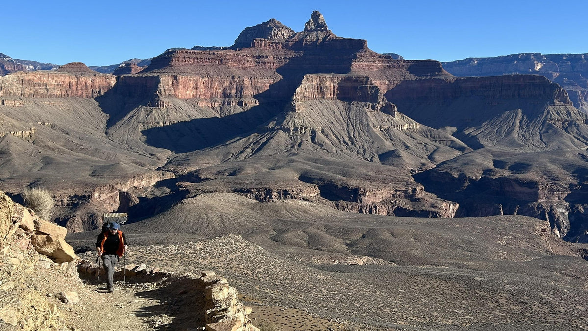 A hiker with a backpack climbs a backcountry trail deep in the Grand Canyon, Arizona. NPS photo