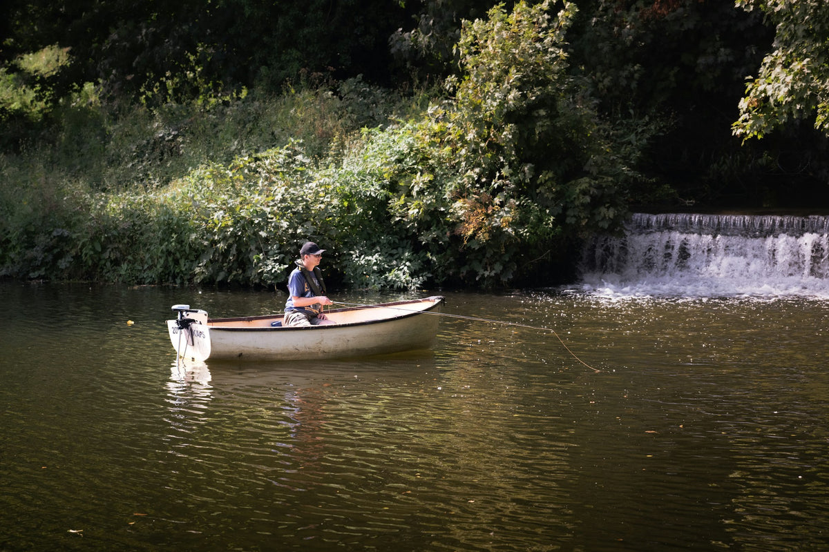 Fisherman rowing a drift boat on the Smith River, Montana