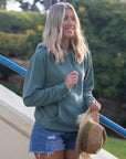 Eternal Fabric Hoodie in Pigment Sage, side view showing relaxed silhouette