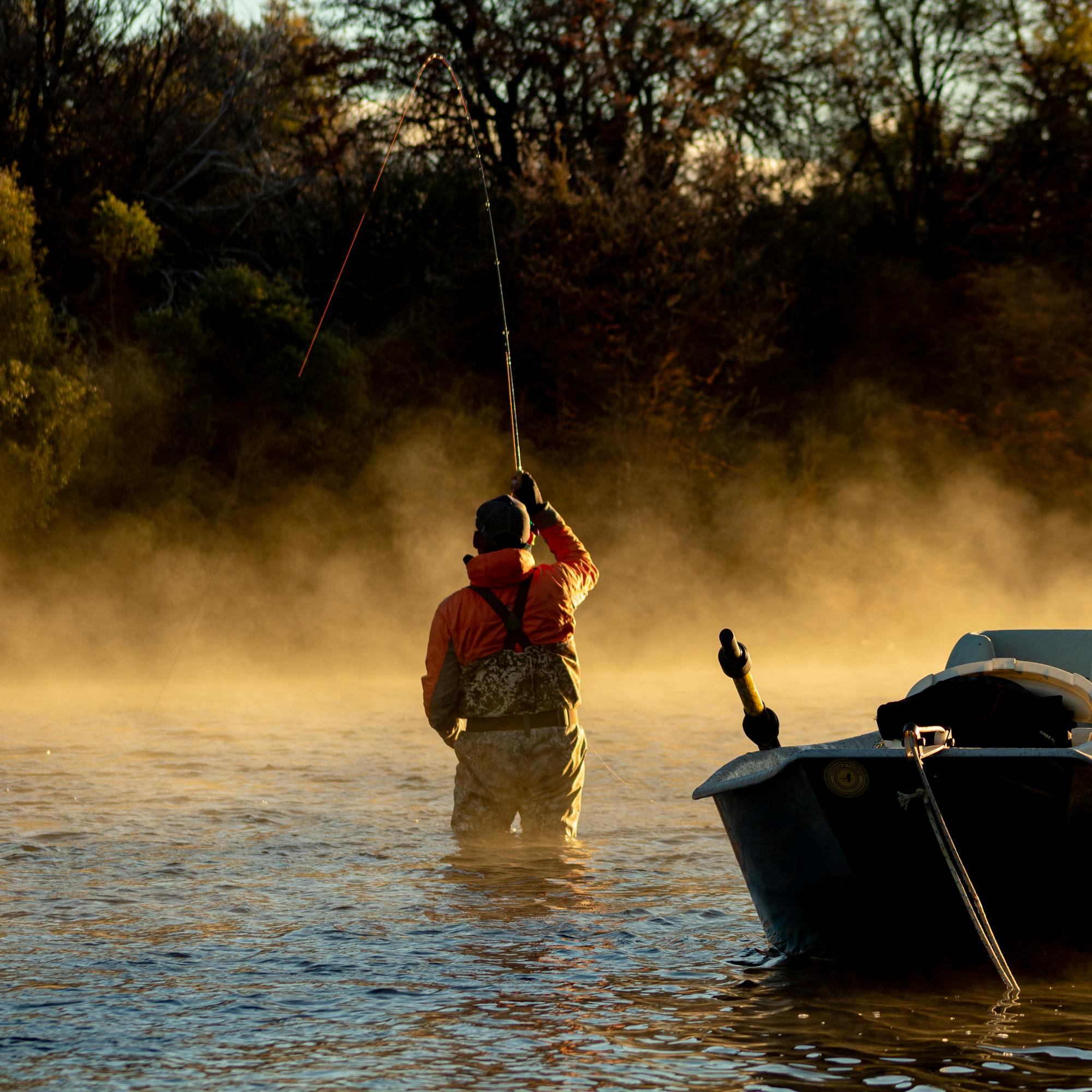 THE DRIFT — Fly fisherman casting at dawn in a misty Patagonian river