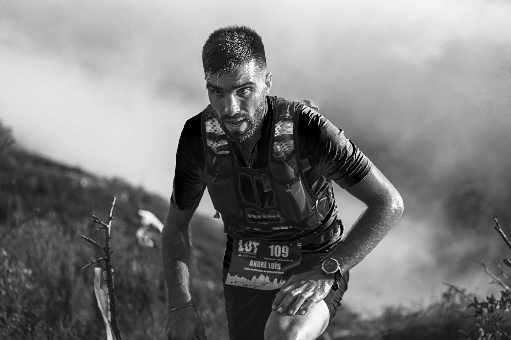 TRAILHEAD — A determined trail runner ascending a rugged mountain trail